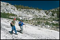 Father and son hiking on granite slab, Le Conte Canyon. Kings Canyon National Park, California (color)