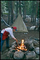 Woman preparing food at campfire, Le Conte Canyon. Kings Canyon National Park, California
