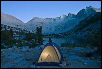 Tent with light and Palisades at dusk, lower Dusy Basin. Kings Canyon National Park, California, USA.