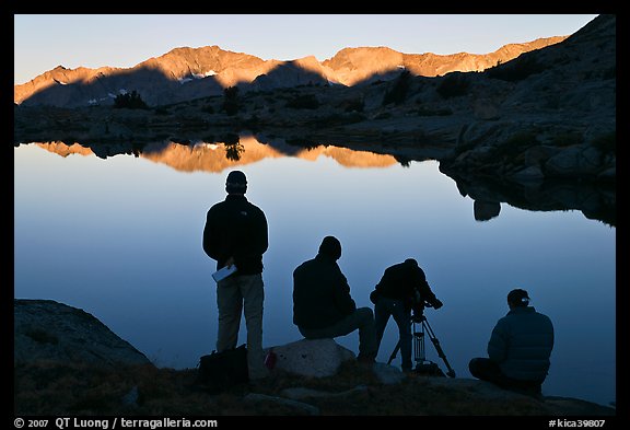 Film crew in action at lake, sunrise, Dusy Basin. Kings Canyon National Park, California