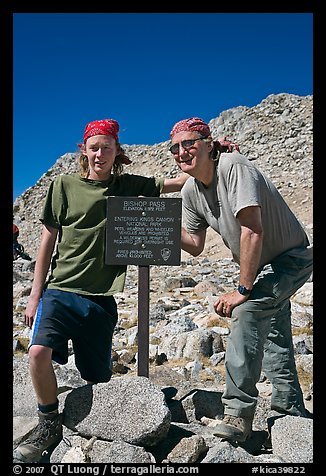 Father and son standing next to Bishop Pass sign. Kings Canyon National Park, California