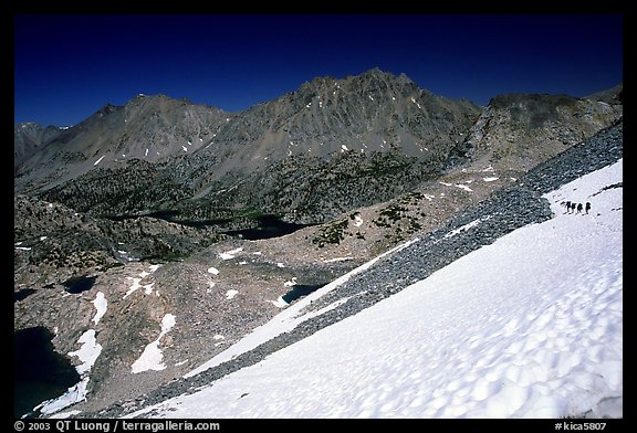 Backpackers on a snow field at a high pass. Kings Canyon National Park, California