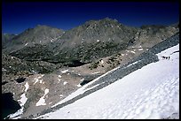 Backpackers on a snow field at a high pass. Kings Canyon National Park, California
