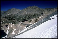 Backpackers on a snow field at a high pass. Kings Canyon National Park, California (color)