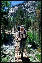 Crossing a river on a suspension bridge. Kings Canyon National Park, California (color)
