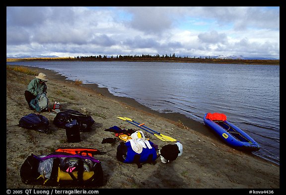 Canoeist packing the camping gear. Kobuk Valley National Park, Alaska