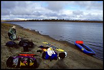 Canoeist packing the camping gear. Kobuk Valley National Park, Alaska (color)