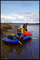Canoeists finish  loading  with the boat prior to launching. Kobuk Valley National Park, Alaska ( color)