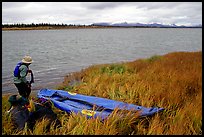 Canoeist deflating the canoe. Kobuk Valley National Park, Alaska ( color)