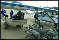 Unloading the gear from the plane to a trailer on the Port Alsworth airstrip. Lake Clark National Park, Alaska