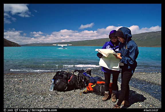 Backpackers orient themselves on the map while the plane is taking off. Lake Clark National Park, Alaska