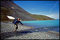 Jumping over a small stream next to Lake Turquoise. Lake Clark National Park, Alaska