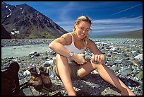 Hiker drying out socks after a stream crossing. Lake Clark National Park, Alaska ( color)