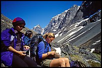 Women hikers pausing below the Telaquana Mountains. Lake Clark National Park, Alaska