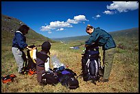 Backpackers breaking camp and readying backpacks. Lake Clark National Park, Alaska ( color)