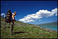 Backpacker looking at Turquoise Lake. Lake Clark National Park, Alaska ( color)