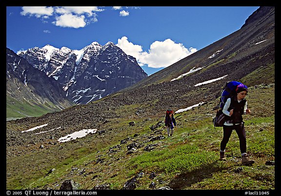 Backpackers walking on a slope. Lake Clark National Park, Alaska