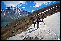 Backpackers crossing a neve. Lake Clark National Park, Alaska ( color)