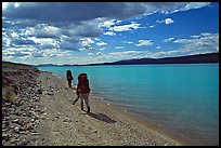 Backpackers walking on the shore of Turquoise Lake. Lake Clark National Park, Alaska (color)