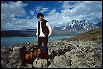 Backpacker pausing on the shore of Turquoise Lake. Lake Clark National Park, Alaska (color)