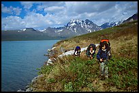 Backpackers travelling cross-country on the shore of Turquoise Lake. Lake Clark National Park, Alaska (color)