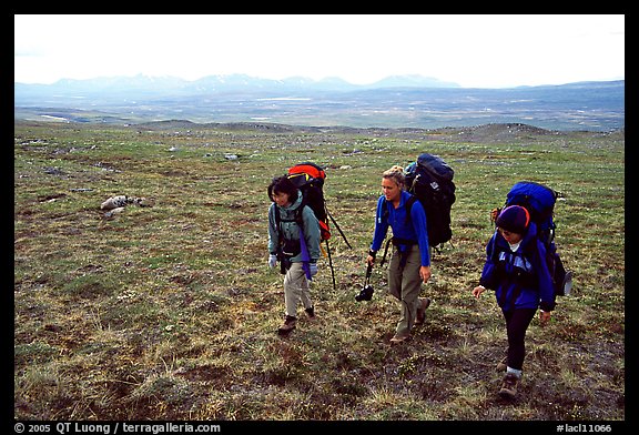 Three women backpackers walking in the tundra. Lake Clark National Park, Alaska (color)