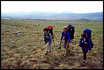 Three women backpackers walking in the tundra. Lake Clark National Park, Alaska (color)