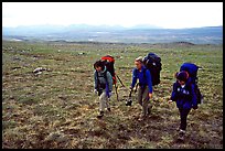 Three women backpackers walking in the tundra. Lake Clark National Park, Alaska (color)