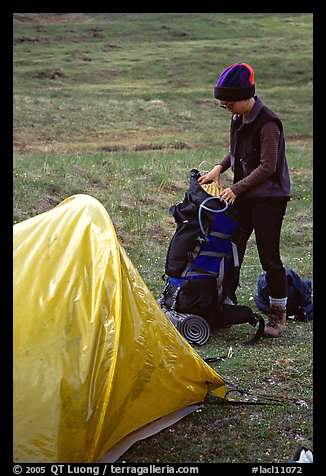 Backpacker unpacking backpack into the tent. Lake Clark National Park, Alaska