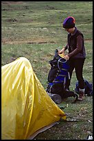 Backpacker unpacking backpack into the tent. Lake Clark National Park, Alaska (color)