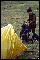 Backpacker unpacking backpack into the tent. Lake Clark National Park, Alaska