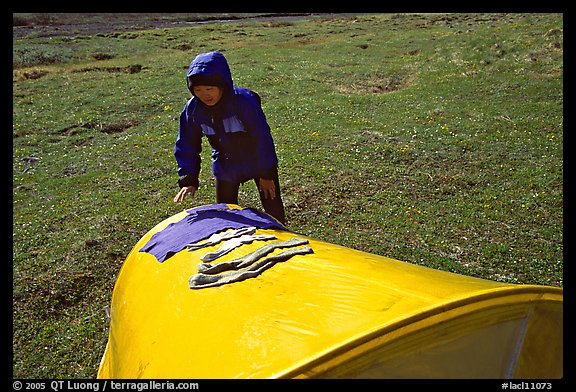 Backpacker drying gear on top of tent. Lake Clark National Park, Alaska (color)