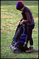 Backpacker finishes packing up backpack. Lake Clark National Park, Alaska