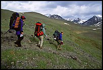 Backpackers with big packs going down a slope. Lake Clark National Park, Alaska ( color)