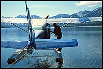 Pilot standing on floats of Floatplane, Twin Lakes. Lake Clark National Park, Alaska