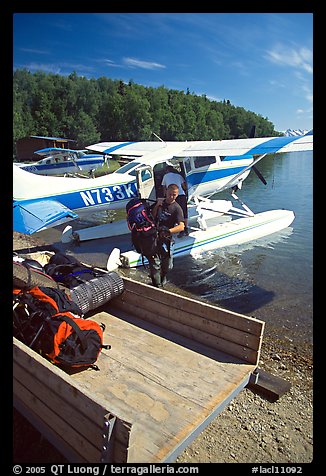 Backpackes being unloaded from floatplane in Port Alsworth. Lake Clark National Park, Alaska (color)