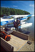 Backpackes being unloaded from floatplane in Port Alsworth. Lake Clark National Park, Alaska ( color)