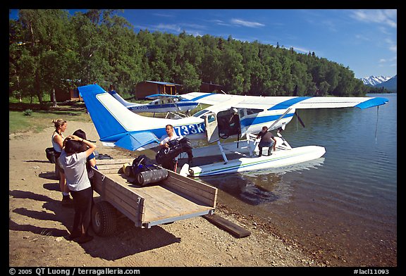 Backpackes being unloaded from floatplane to a trailer in Port Alsworth. Lake Clark National Park, Alaska (color)