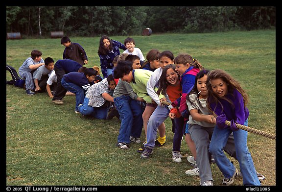 Children playing tug-of-war with a rope. Lake Clark National Park, Alaska