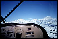 From the cockpit. The three main summits of the range are, from left to right, Mt Foraker, Mt Hunter, and Mt McKinley, which is cloud-capped, as often. Alaska (color)