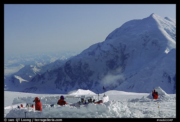The low-profile tents have to be protected against the wind (which can reach 100mph). Climbers dig a hole and built thick snow-walls by sawing off large chunks of frozen snow. Denali, Alaska (color)