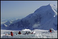 The low-profile tents have to be protected against the wind (which can reach 100mph). Climbers dig a hole and built thick snow-walls by sawing off large chunks of frozen snow. Denali, Alaska (color)