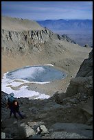 Woman on steep slope above frozen Iceberg Lake. Sequoia National Park, California (color)