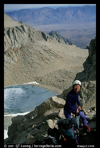 Woman gearing up to climb  East face of Mt Whitney. California (color)