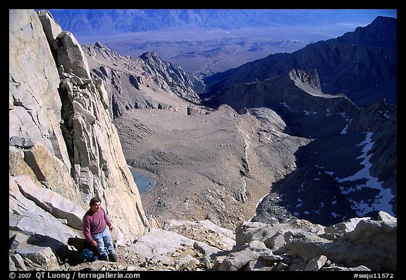 Man pausing on steep terrain in the East face of Mt Whitney. Sequoia National Park, California