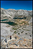 Hikers on trail above Saddlebag Lakes, John Muir Wilderness. Kings Canyon National Park, California