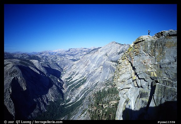 Hiker standing on top of Half-Dome, overlooking Tenaya Canyon. Yosemite National Park, California (color)