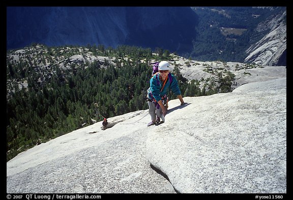 Rock climbers on the Snake Dike route, Half-Dome. Yosemite National Park, California (color)
