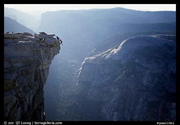 Hanging dramatically from the Jumping Board, Half-Dome. Yosemite National Park, California