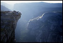 Hanging dramatically from the Jumping Board, Half-Dome. Yosemite National Park, California (color)